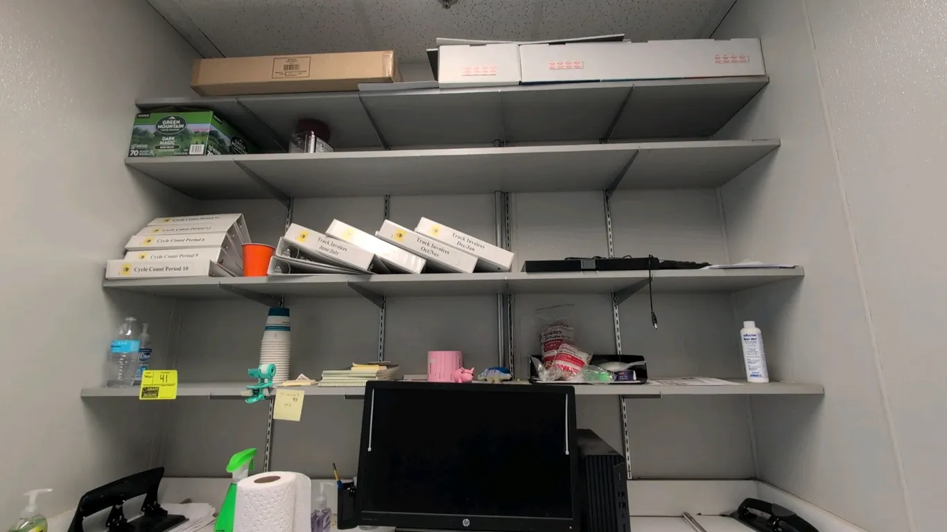 Laminate 4-tier wall-mounted shelving unit. Features gray laminate shelves with slotted wall standards and adjustable support brackets. 77"L. Contents