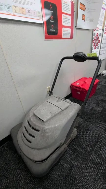 Walk-behind battery-powered floor sweeper. Features digital control interface with battery level indicator, selectable sweeping modes, onboard battery