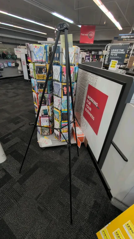 Metal tripod display easel. Features black tubular metal construction with folding legs and cross bracing. 5'H.