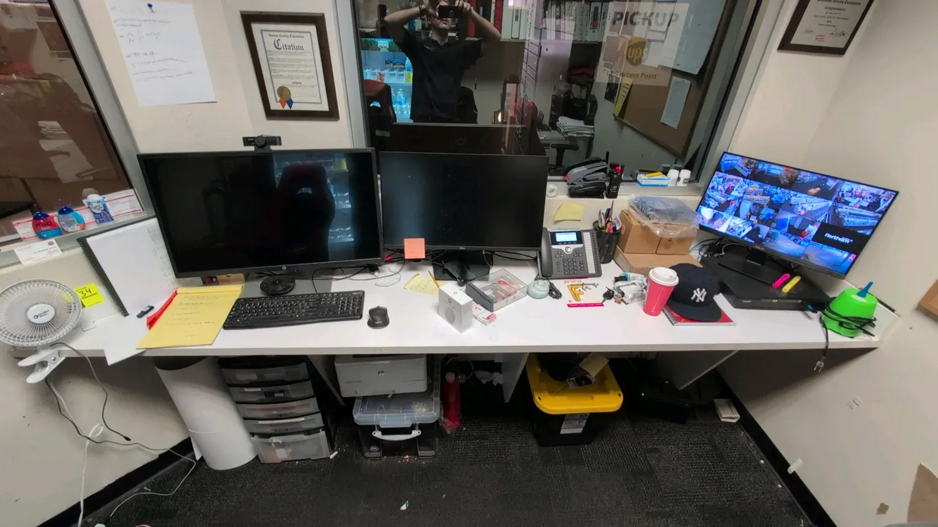 Laminate countertop desk surface. Features a white laminate finish and wall-mount support brackets. 9'L. Contents, monitors, and electronics not inclu