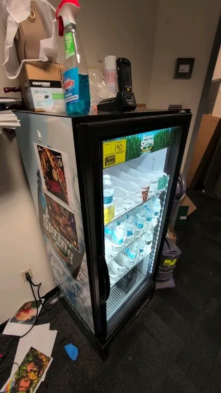 True GDM-12-HC~TSL01 single-door glass door merchandiser cooler. Features illuminated Poland Spring canopy, hinged glass display door, interior LED li