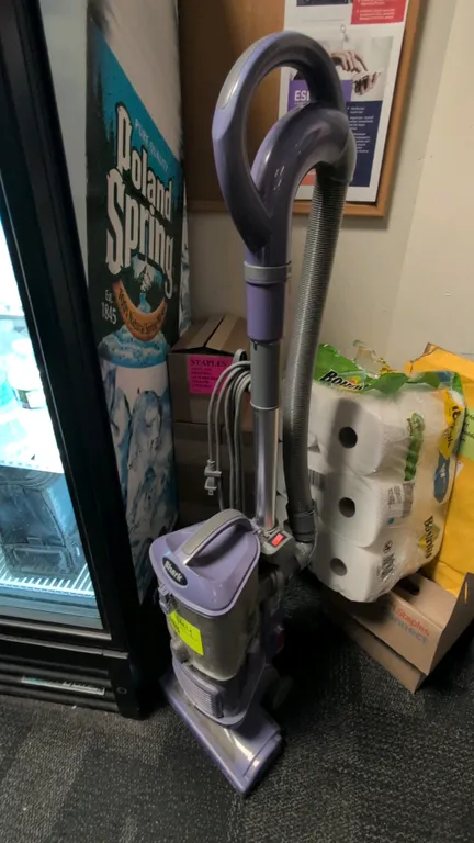 Shark NV352 V5 upright vacuum cleaner. Features bagless dust cup design, detachable extension wand, flexible stretch hose, and integrated cord wrap. E