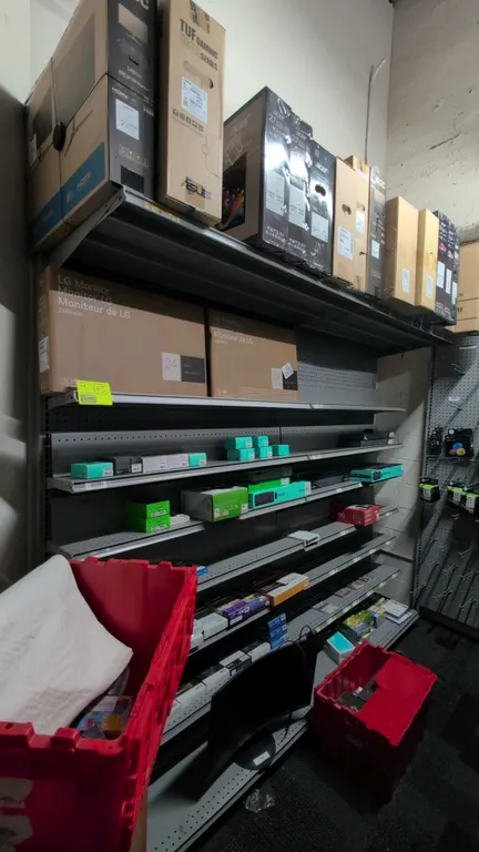 8'L of Madix wall shelving. Features 84"H uprights, 18"D base shelves, adjustable metal shelves, pegboard backing, and an integrated top storage rack.