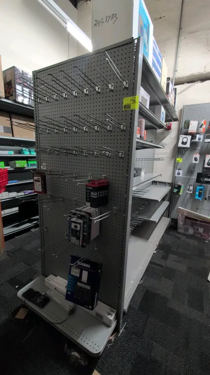 19'L of Madix gondola shelving. Features 84"H uprights, 18"D base shelves, gray finish, and pegboard backing. Includes upper shelves and peg hooks. Co
