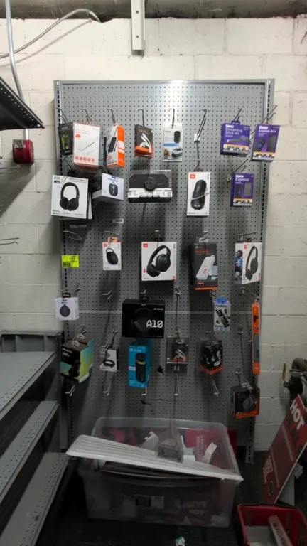 8'L of Madix gray wall shelving with pegboard backing panels. Features 8'H uprights with pegboard panels. Gray finish. Contents and hanging merchandis