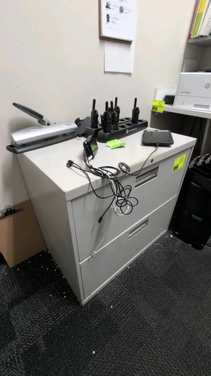 Metal 2-drawer lateral filing cabinet. Features recessed pull handles and gray finish. 30"W x 28"H. Contents not included.