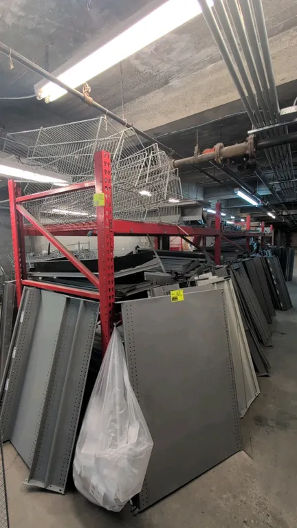 8'L Madix teardrop pallet racking. Features 3-1/2" crossbeams and wire decking. Max capacity: 4,950 lbs per pair. Dimensions: 4'W x 7'H. Contents not