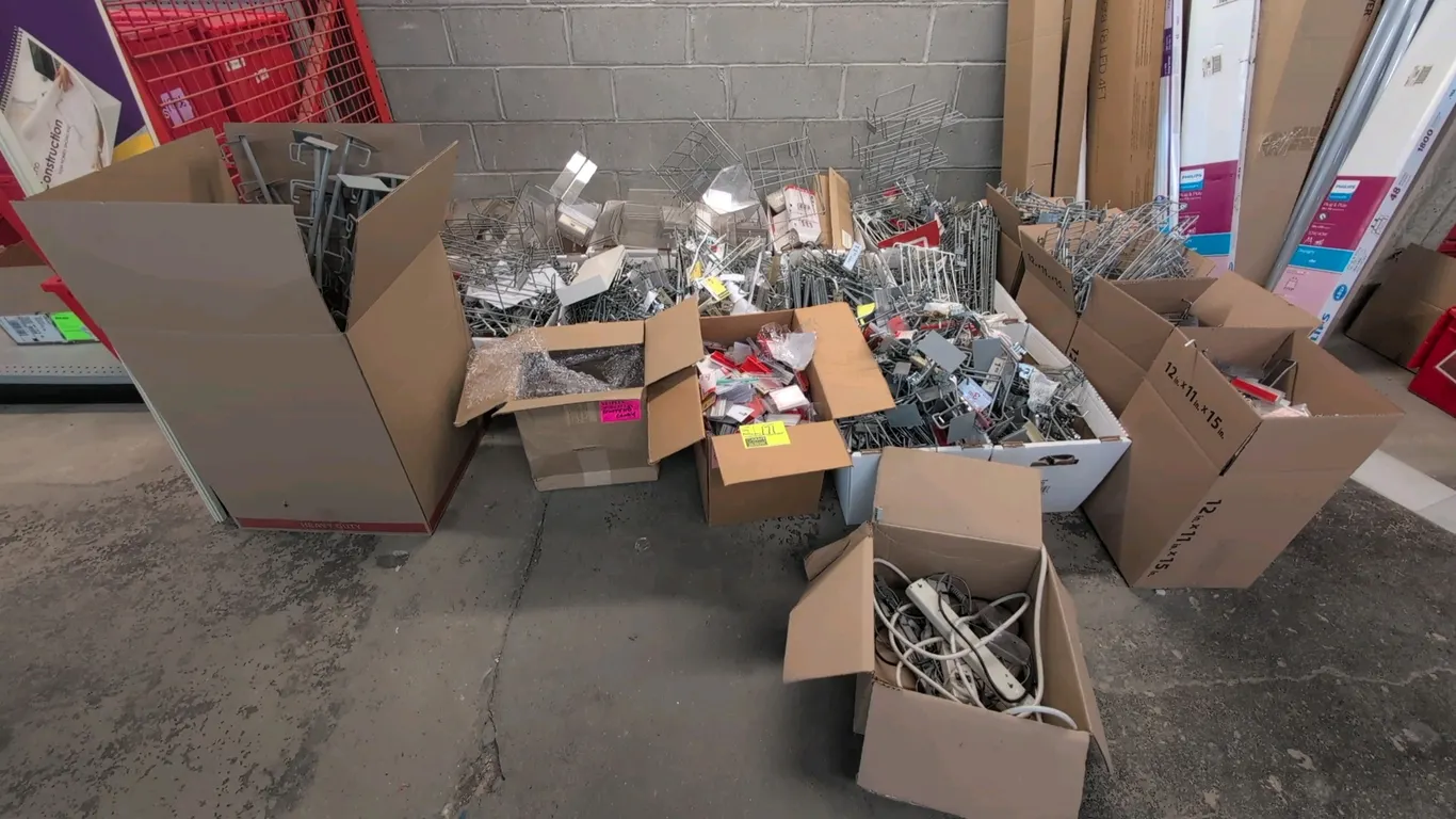 Assorted retail merchandising accessories. Includes metal pegboard and slatwall display hooks, scanner hooks, plastic shelf label holders, sign holder