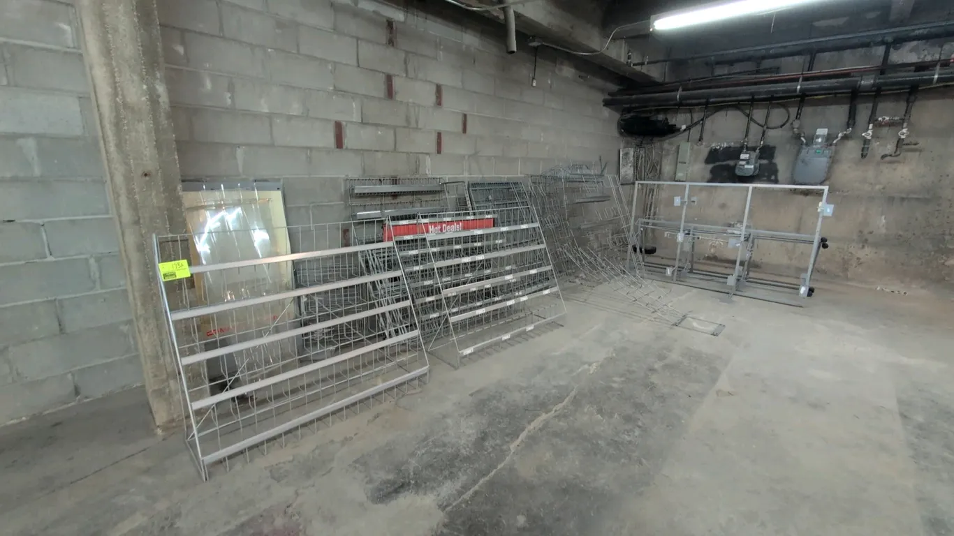 Assorted retail merchandise display racks. Includes tiered wire display racks with integrated price channels, tiered literature/counter displays, and