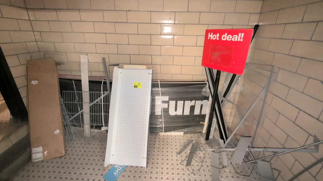 Assorted retail merchandising and display supplies. Includes metal wire racks and baskets, sign holders, promotional signage, pegboard display panel,