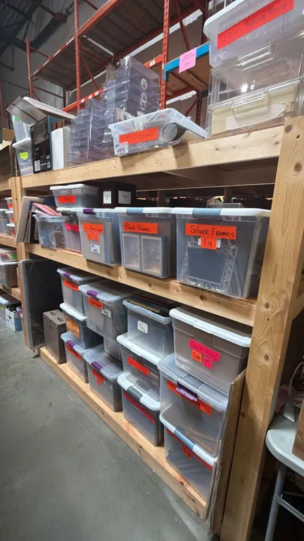 3 SHELVES OF ASSORTED PICTURE FRAMES IN PLASTIC STORAGE BINS