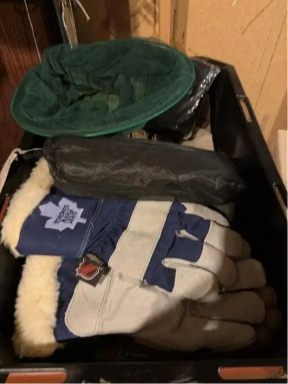 Bin with assorted outdoor gloves and fly masks