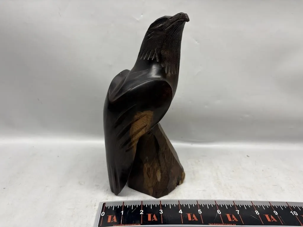 Carved wooden bird sculpture on base
