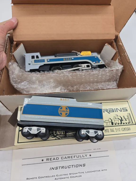 The vintage marxs train's Santa Fe steam locomotive and tinder number 8352 new inbox.
