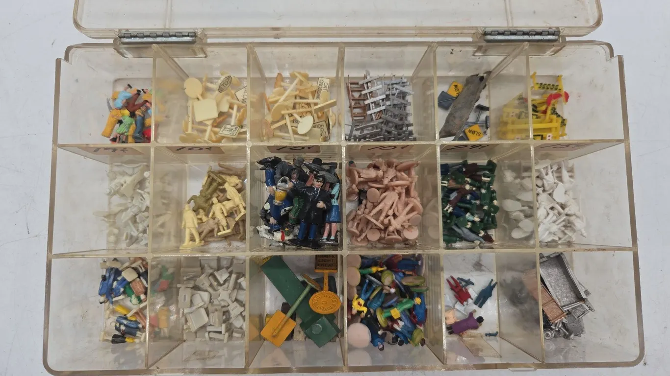 Large assortment of h o scale people and accessories in plastic storage container