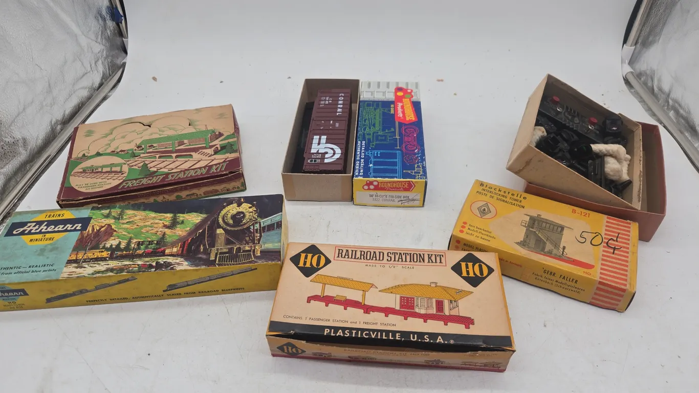 Assorted vintage train cars and accessories.New inboxes