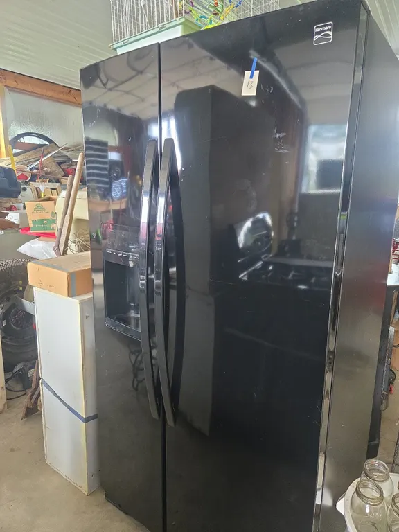 Kenmoore cold spot side by side refrigerator with Ice dispensing door.