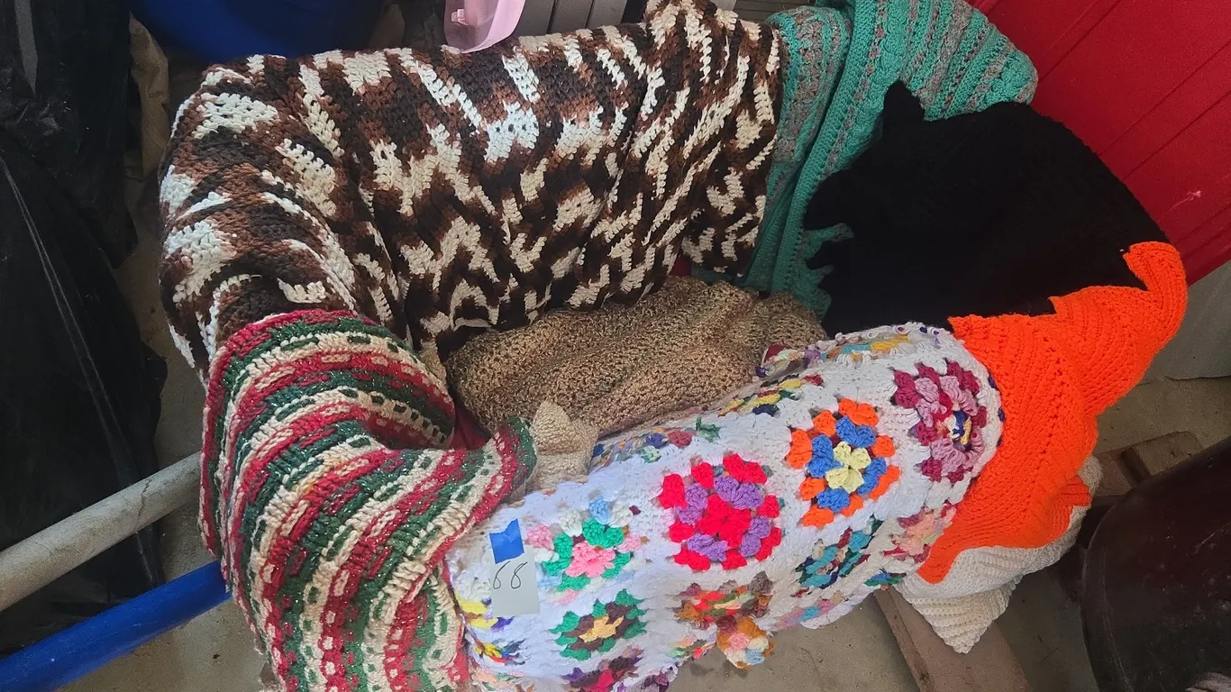 Large assortment of hand crocheted afgans