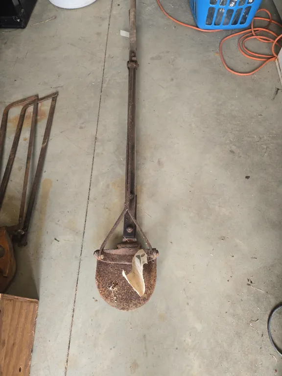 Antique lever action post hole digger