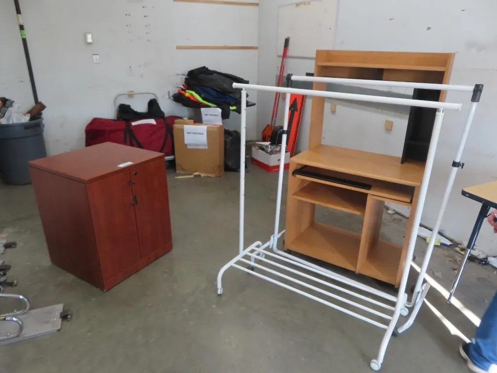 Lot - (2) Portable Garment Racks, Cherry 2 Door Cabinet, Small Workstation, Brwon Double Pedestal Desk, white board, Single Pedestal Desk *Located at