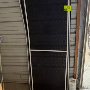 Assorted screen doors. Features metal frames with mesh screening in white and dark finishes.