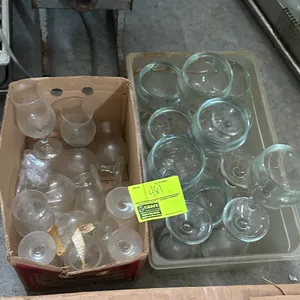 Assorted glassware. Includes stemmed cocktail glasses, specialty drinkware, and large stemmed goblets. Contained in (1) cardboard box and (1) plastic 