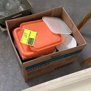 Assorted lot of container lids and plates. Includes square plastic food storage container lids and round serving plates. Packed in box.