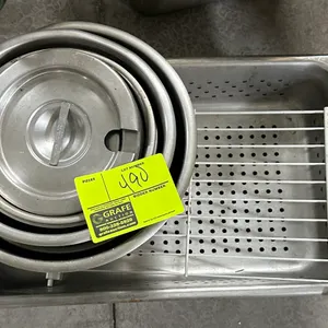 Assorted stainless steel kitchenware. Includes nested mixing bowls with a notched lid, a perforated steam table insert pan, and a wire rack.