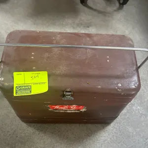 Vintage Thermaster metal ice chest cooler. Features a top metal bail handle, front latch closure, and brown painted exterior.