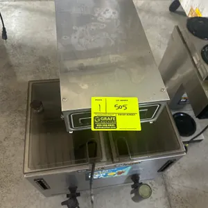 Bunn stainless steel tea brewer. Features dual dispenser reservoir with spigots and translucent lids. Countertop design.