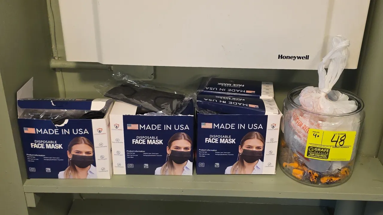 Personal protective equipment lot. Includes Sovereign America 3-ply black disposable face masks with ear loops and a glass jar containing individually