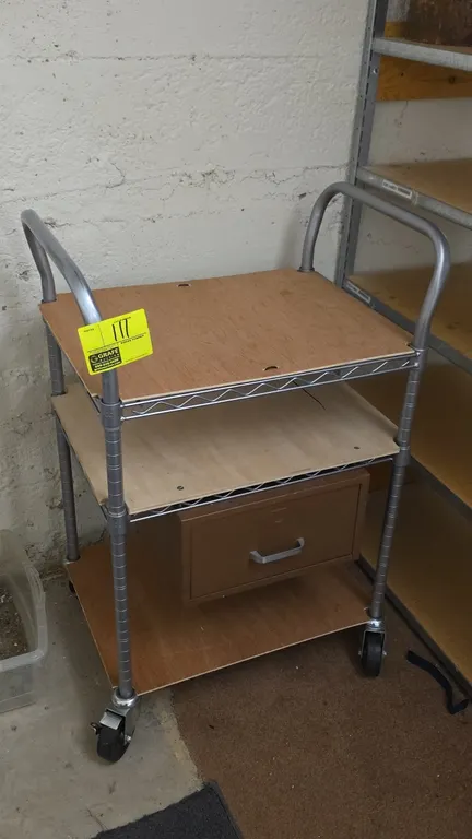 Metro 3-tier metal utility cart. Features wire shelving with wood board shelf inserts, a single under-shelf pull-out drawer, and dual tubular push han