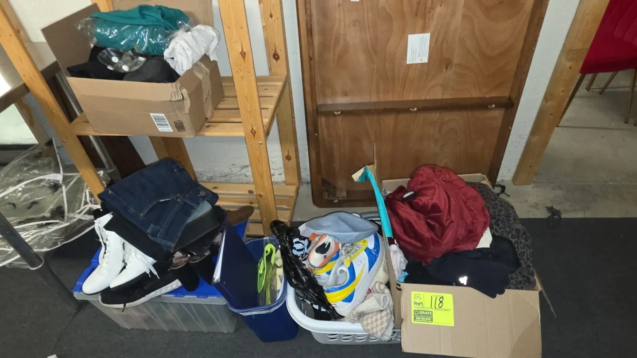 Assortment of clothing and footwear. Includes assorted apparel, jeans, athletic shoes, boots, casual sneakers, and accessories packed in cardboard box