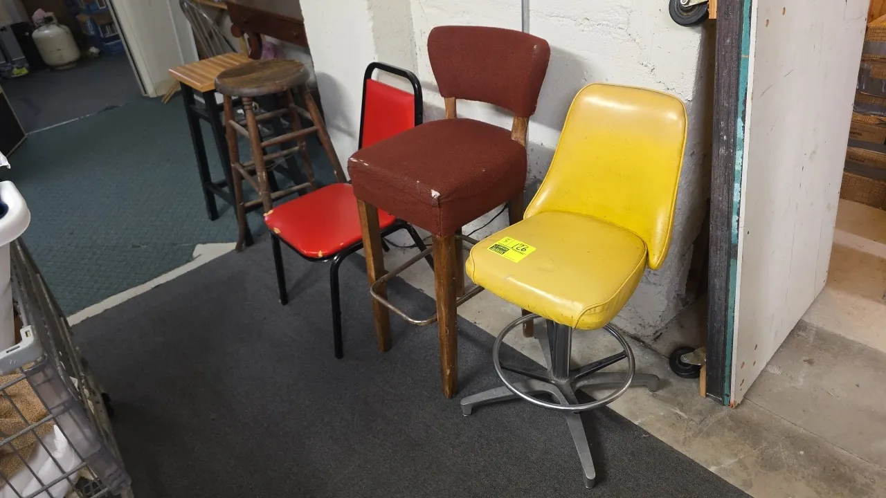 Assorted seating lot. Includes (1) yellow vinyl swivel bar stool with metal footring base, (1) brown fabric upholstered high bar stool on wood legs, (