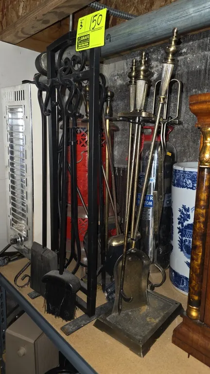 Metal fireplace tool sets. Assorted styles including black wrought iron-style scroll stand and brass-tone stands with decorative finials. Includes sta