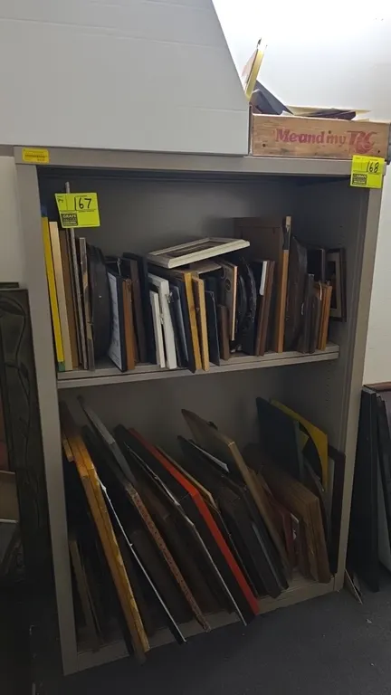 Metal 3-tier bookcase shelving unit. Features painted gray metal construction with open shelves. Dimensions: 38"W x 15"D x 55"H. Contents not included