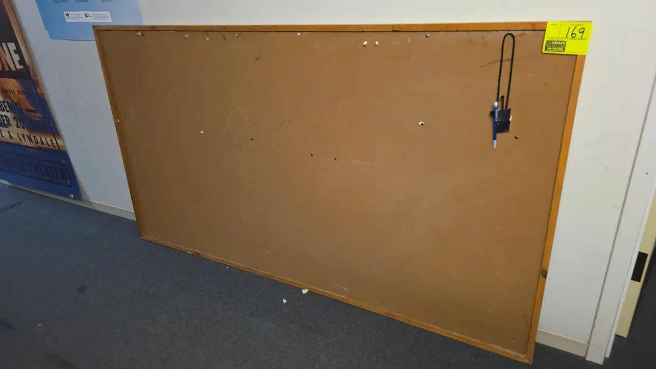 Wood frame cork bulletin board. 77" x 43".