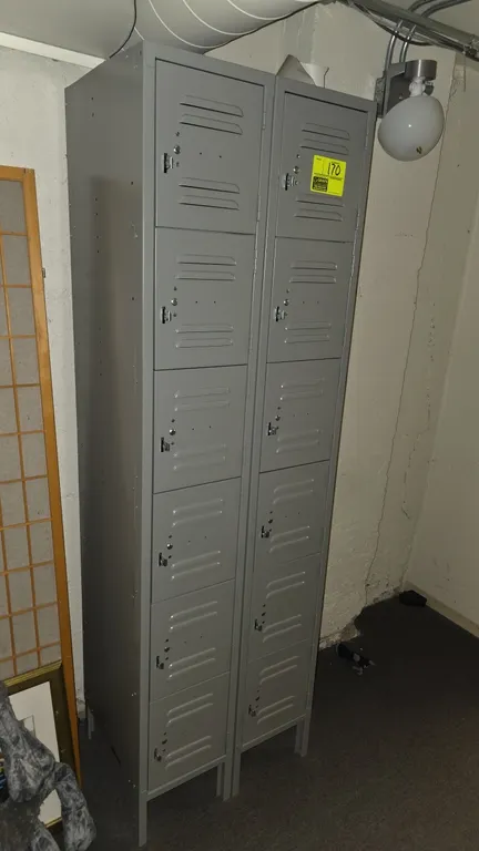 Metal 6-compartment lockers. Includes (2) 6-tier single-column locker units. Features louvered doors with padlock hasps and gray painted finish. 12" x