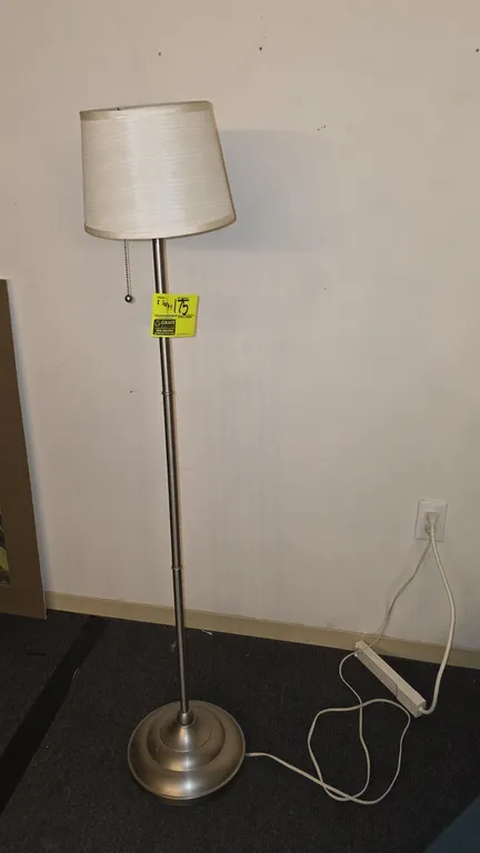 Assorted floor lamps. Includes (1) brushed silver-tone metal floor lamp with fabric drum shade and pull-chain switch, and (2) black metal torchiere fl