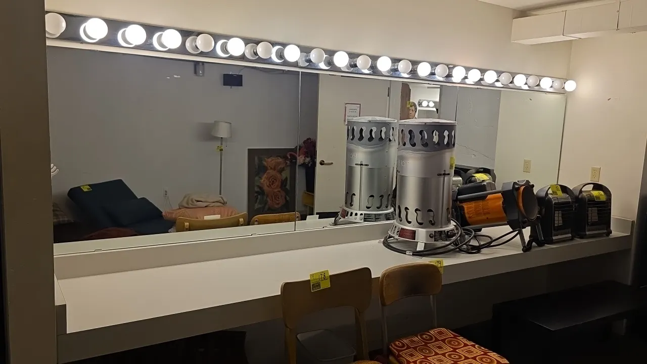 Laminate vanity dressing station. Includes (3) 4' x 3' mirrors and (3) 4' 8-socket vanity light fixtures. Dimensions: 12' x 2'. Wall-mounted design wi