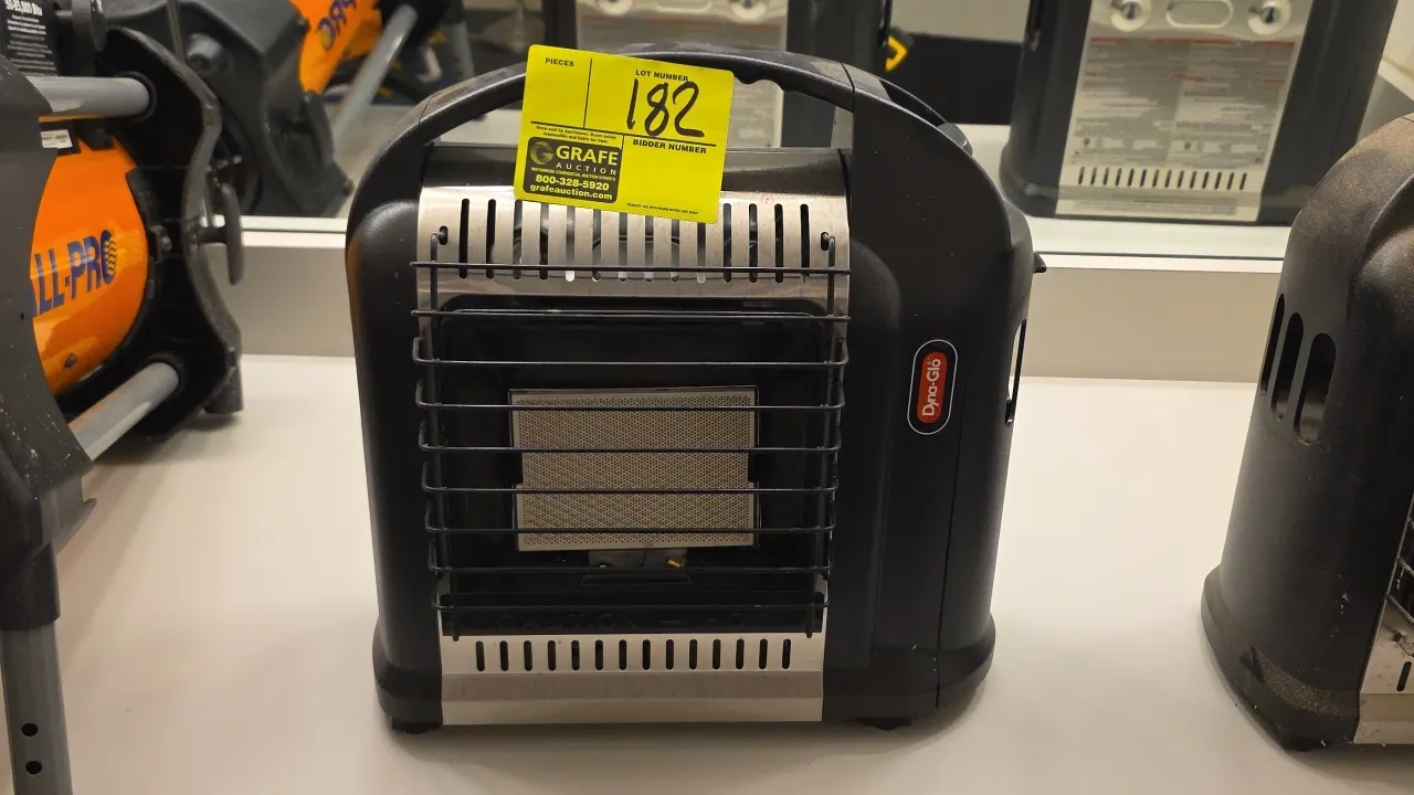 Dyna-Glo RMC-8001SS portable propane gas heater. Features integrated carry handle, wire safety guard, and variable heat control dial with pilot igniti