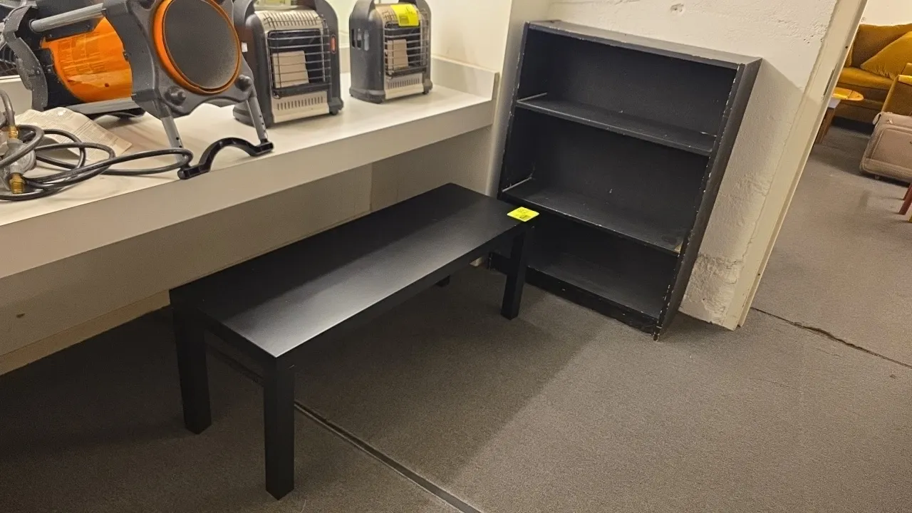Laminate wood bench and bookcase lot. Includes (1) bench measuring 48"L and (1) 3-shelf bookcase measuring 42"H. Features black laminate wood construc