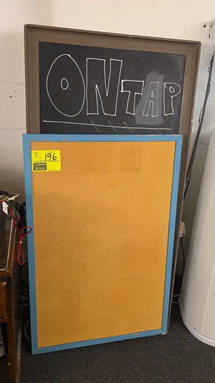 Wood-framed cork board and chalkboard. Includes 37"H cork bulletin board with blue-painted wood frame and 50"H chalkboard with brown wood frame.