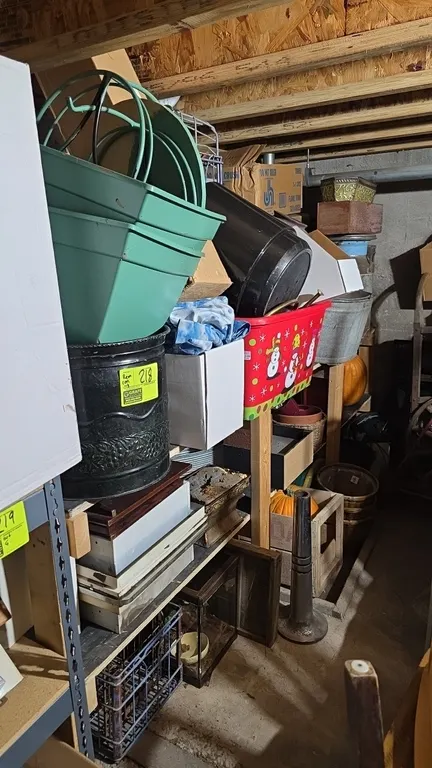 Assorted decor and storage contents lot. Includes 2-tier wood shelf, storage bins and tubs, holiday decor, plastic and metal planters, baskets, wooden