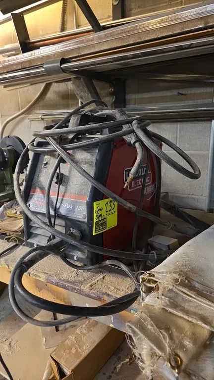 Lincoln Electric Weld-Pak 100 wire feed welder. Includes welding gun, ground clamp cable, and welding gloves. S/N: U1001007478. Electrical: 115V, 60 H