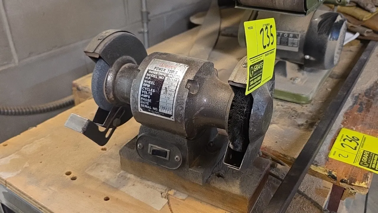 1983 Standard CL-115 5" bench grinder. Features grinding wheel, wire wheel brush, left-side tool rest, and front toggle switch. S/N: 112563. Electrica
