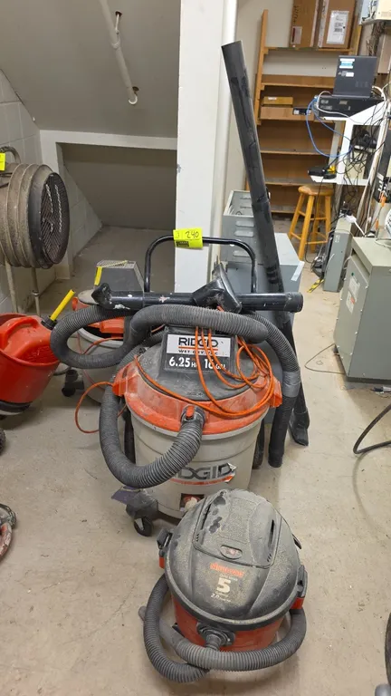 Assorted wet/dry shop vacuums. Includes (1) Ridgid 16-gallon 6.25 peak HP vacuum on cart, (1) Ridgid 12-gallon 4.25 peak HP vacuum, and (1) Shop-Vac Q
