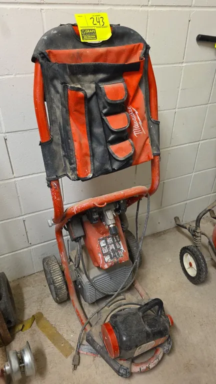Milwaukee 2-stage turbine HVLP fine finish paint sprayer. Features integrated control panel, attached Milwaukee fabric storage pouch, and tubular fram