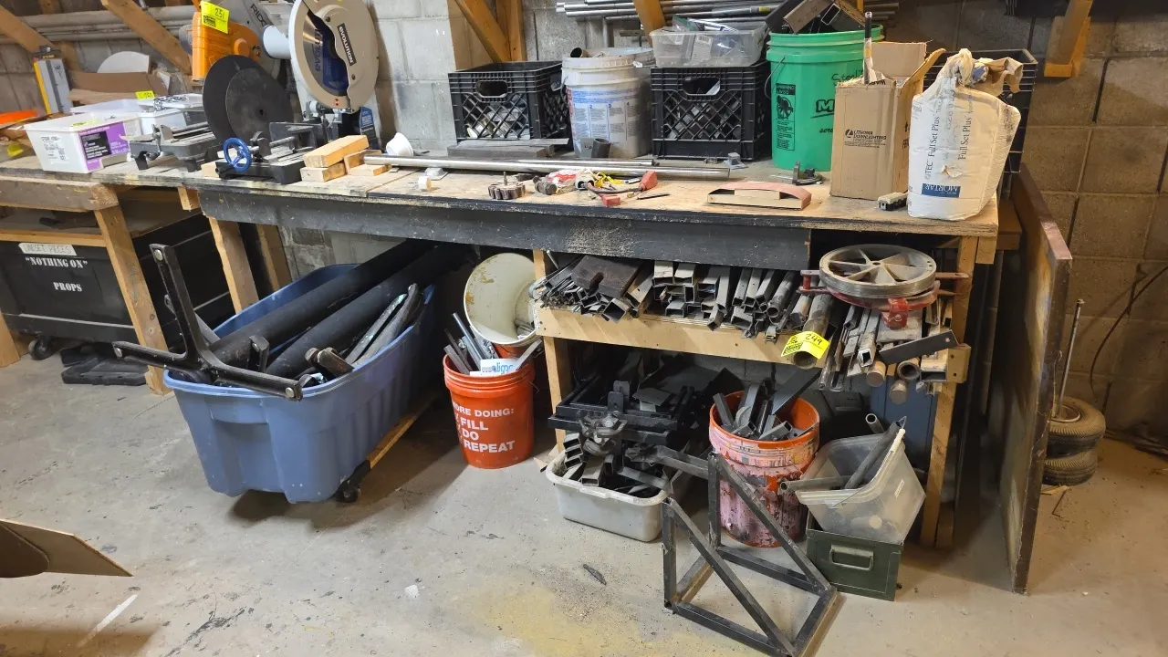 Assorted metal stock and scrap lot. Includes square and rectangular tubing, round pipe, flat bar stock, brackets, and cutoffs in various sizes. Stored
