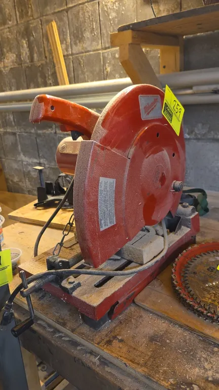Milwaukee abrasive cut-off saw. Features integrated material vise clamp, spark/wheel guard, and D-handle with trigger switch. Electrical: 120V. Extra
